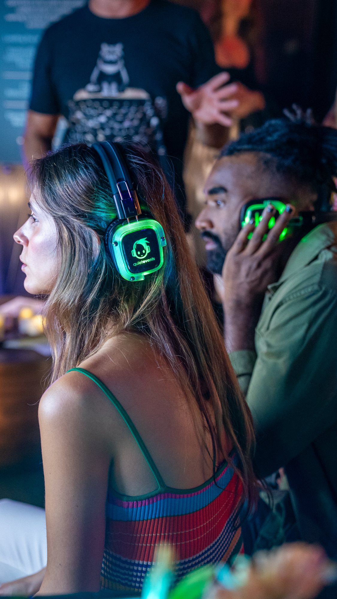 Guest listening on glowing headphones